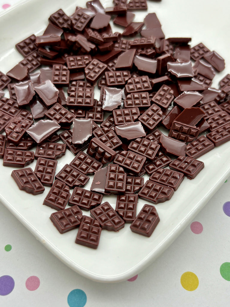 a white plate topped with chocolate covered waffles