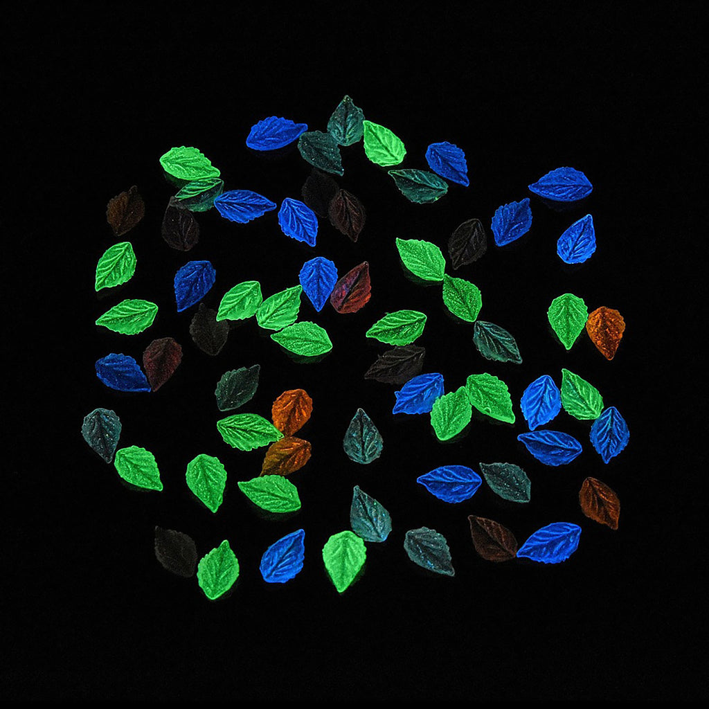 a collection of colorful leaves scattered across a dark background.
