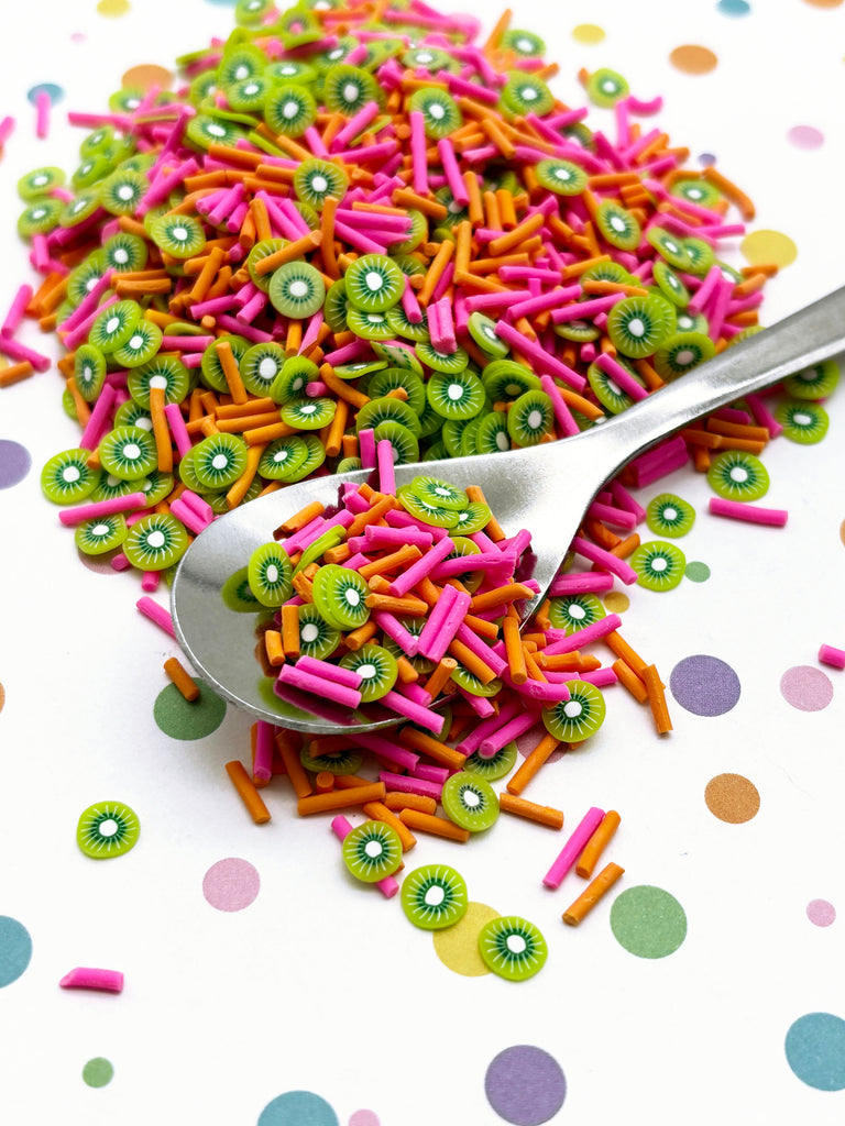 a pile of sprinkles with a spoon on top of it