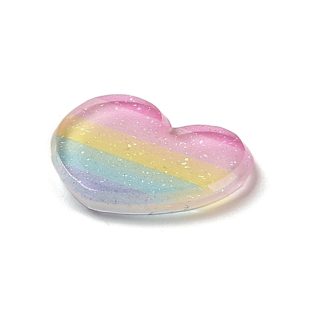 a rainbow heart shaped candy on a white background