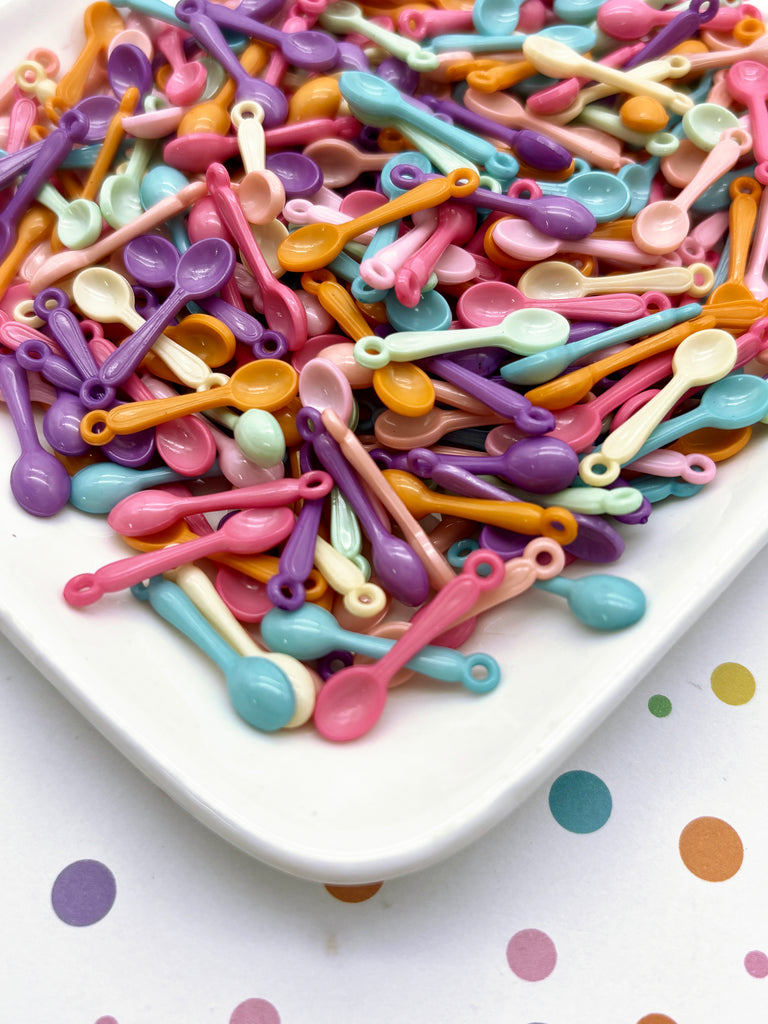 a white plate topped with lots of colorful scissors