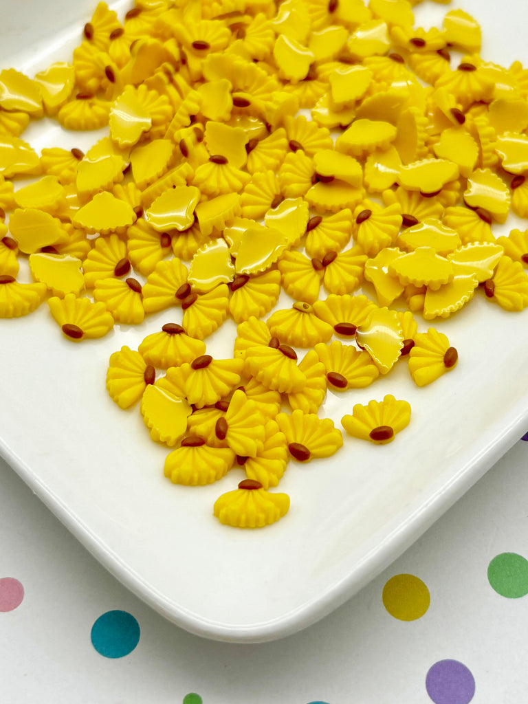 a white plate topped with yellow macaroni shells