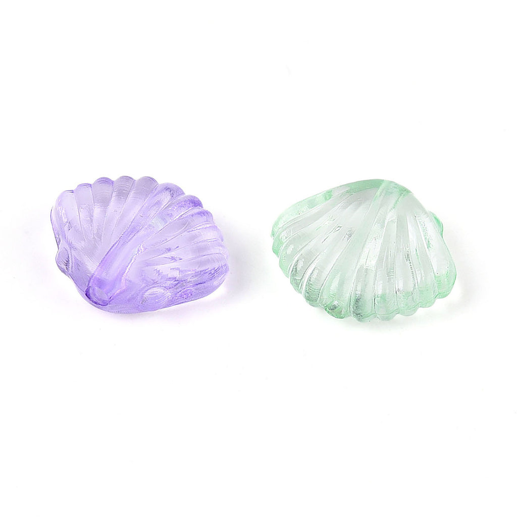 two seashells, one purple and one green, against a white background.
