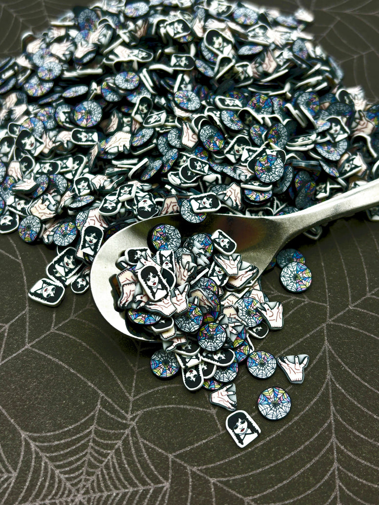 a spoon filled with lots of blue and white buttons