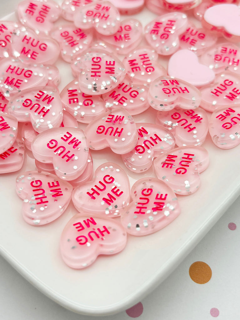 a white plate topped with lots of pink candy hearts