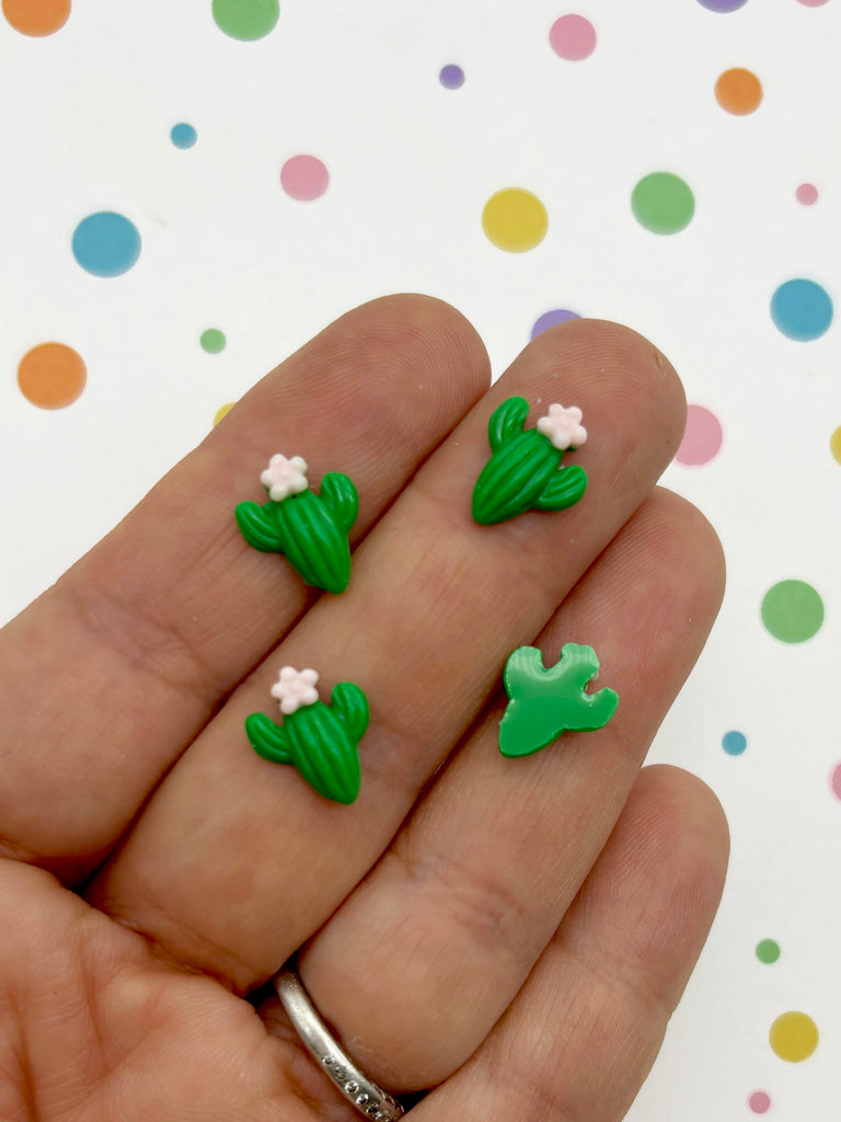 a person is holding some tiny green and white flowers