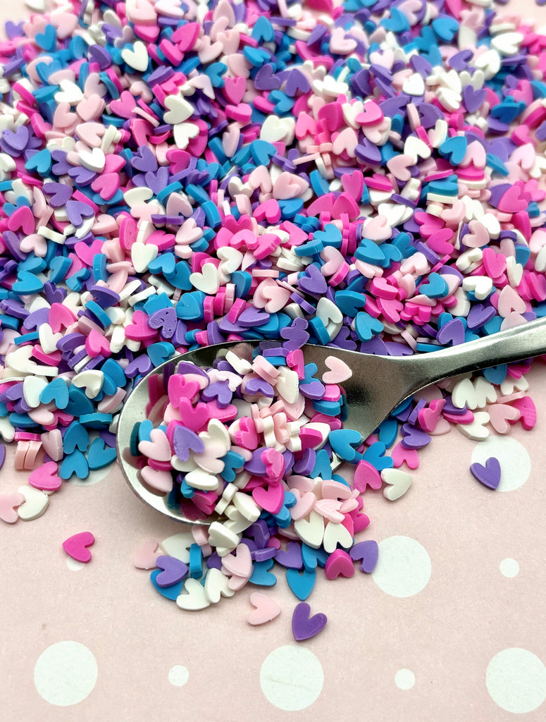 a spoon full of confetti sprinkles on a table