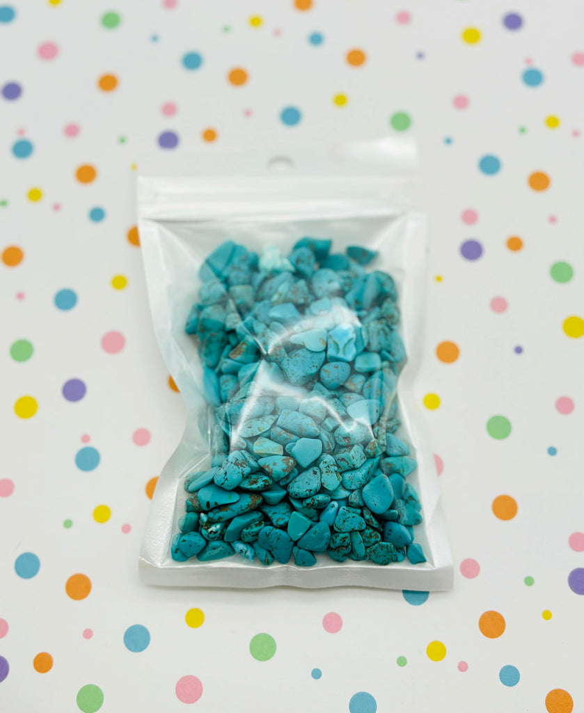 a bag of blue rocks sitting on top of a table