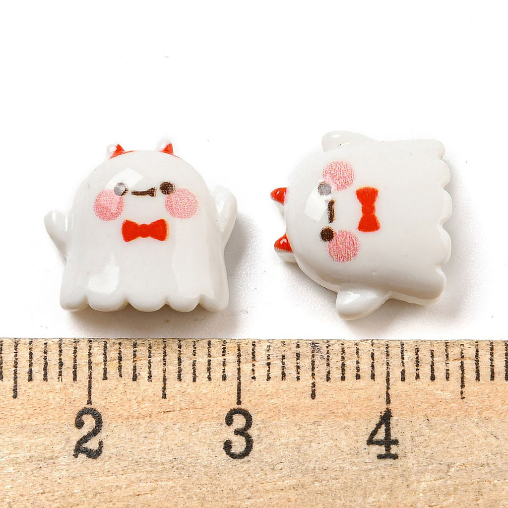 a measuring tape and two white ghost buttons