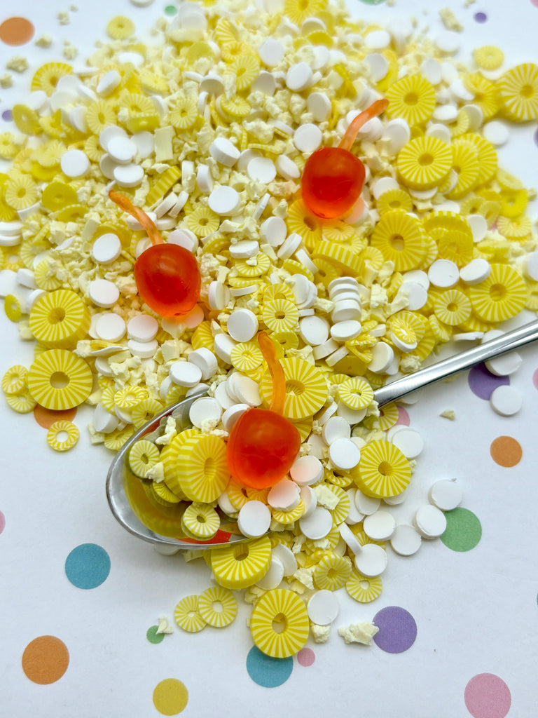 a spoon full of candy sitting on top of a table