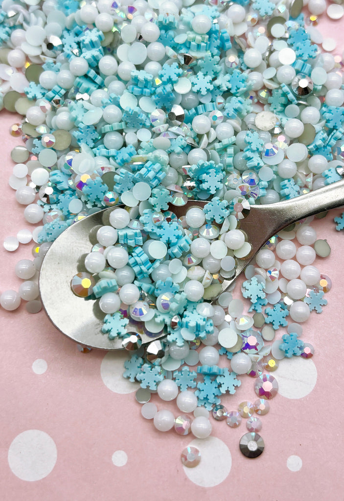 a spoon full of blue and white beads