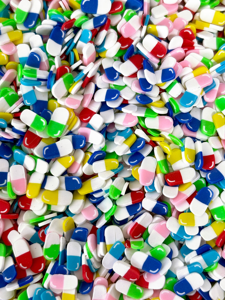 a pile of colorful pills sitting on top of a table