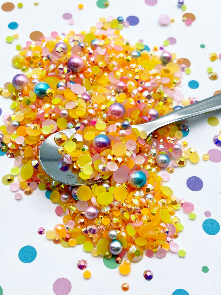 a spoon sitting on top of a pile of confetti