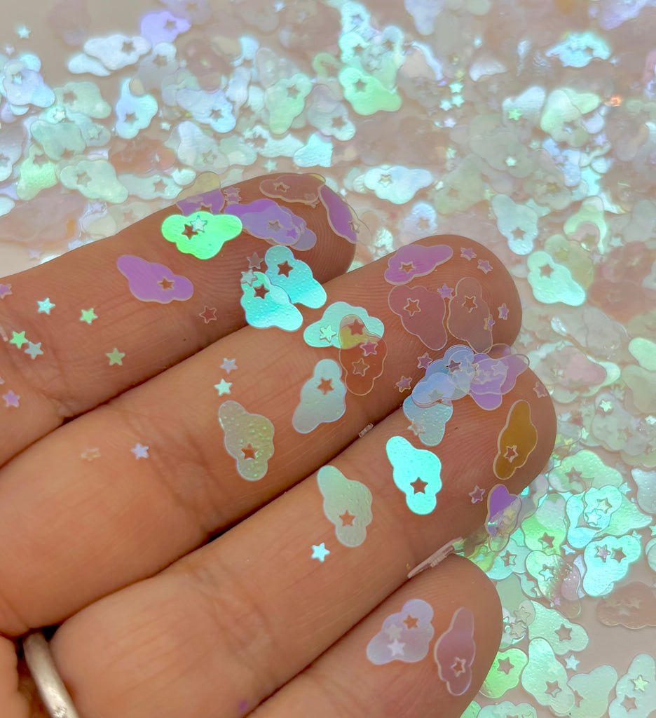 a hand holding a manicured mani with glitter on it