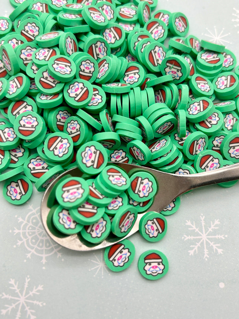 a pile of green buttons sitting on top of a table