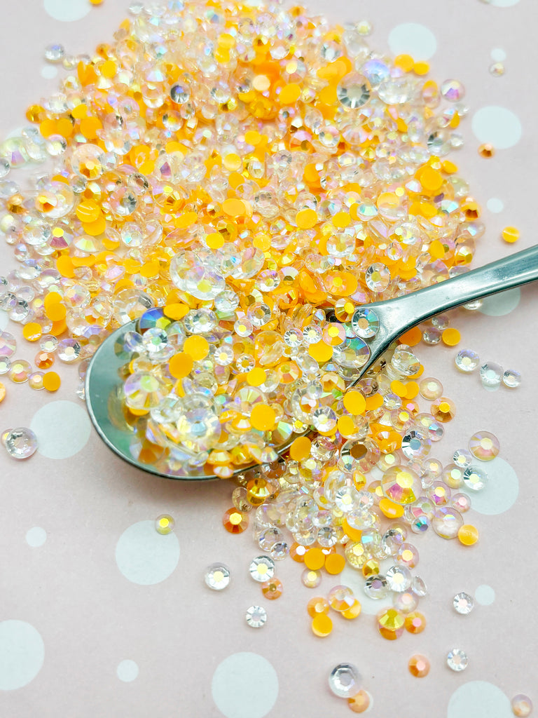 a spoon filled with yellow and white glitter