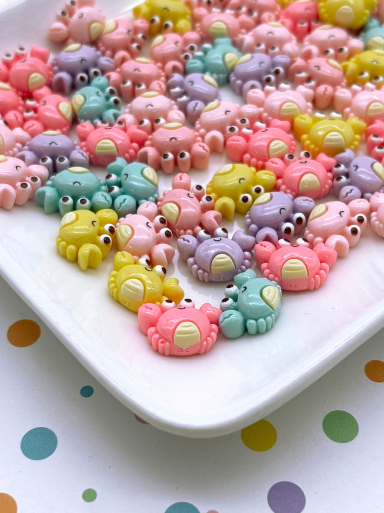 a white plate topped with lots of small toy elephants