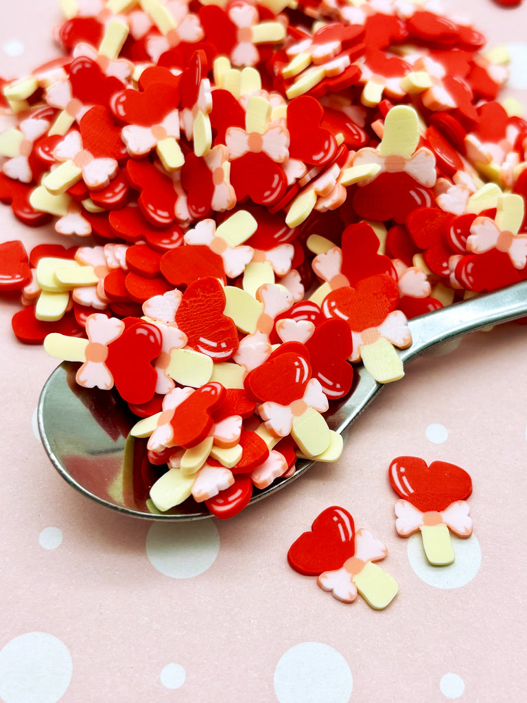 a spoon full of candy hearts on a table