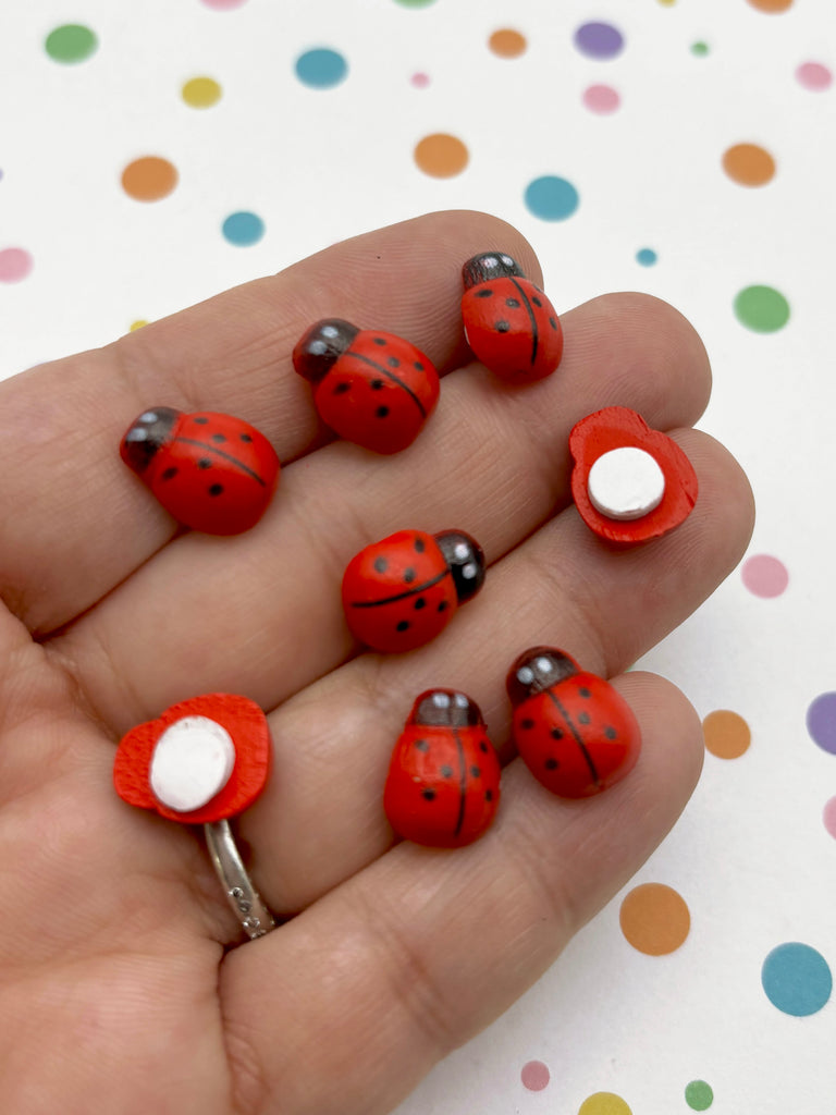 a person is holding a bunch of ladybugs in their hand