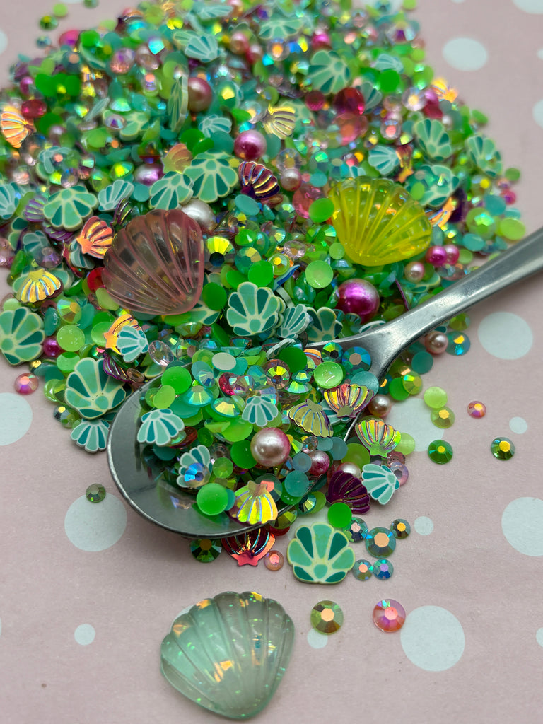 a spoon full of green and purple beads