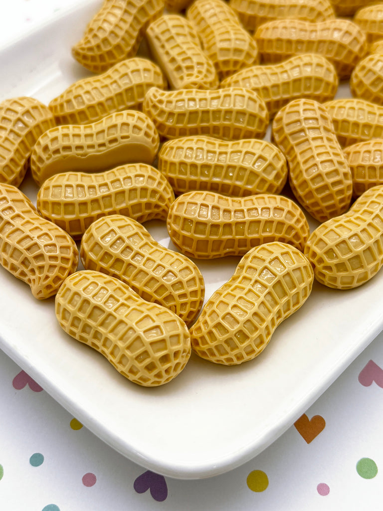 a white plate topped with peanuts on top of a table