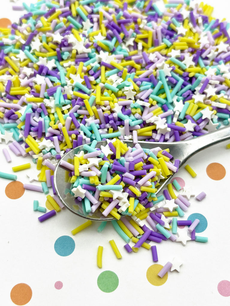 a spoon filled with sprinkles on top of a table