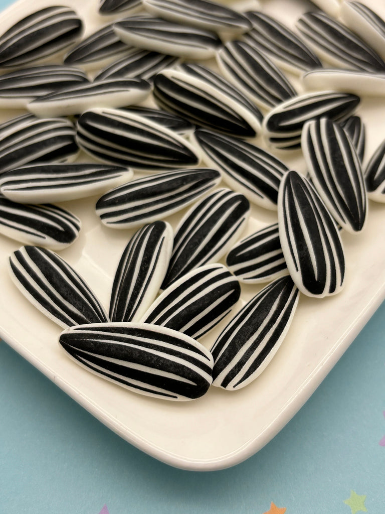 a white plate topped with black and white striped cookies