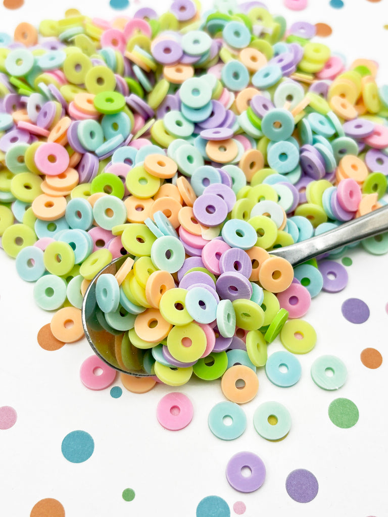 a spoon is sitting on a pile of buttons