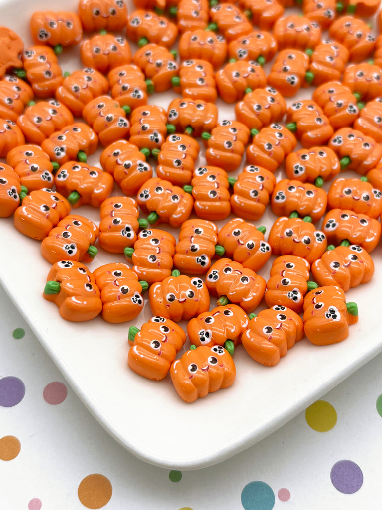 a white plate topped with lots of carrots covered in googly eyes