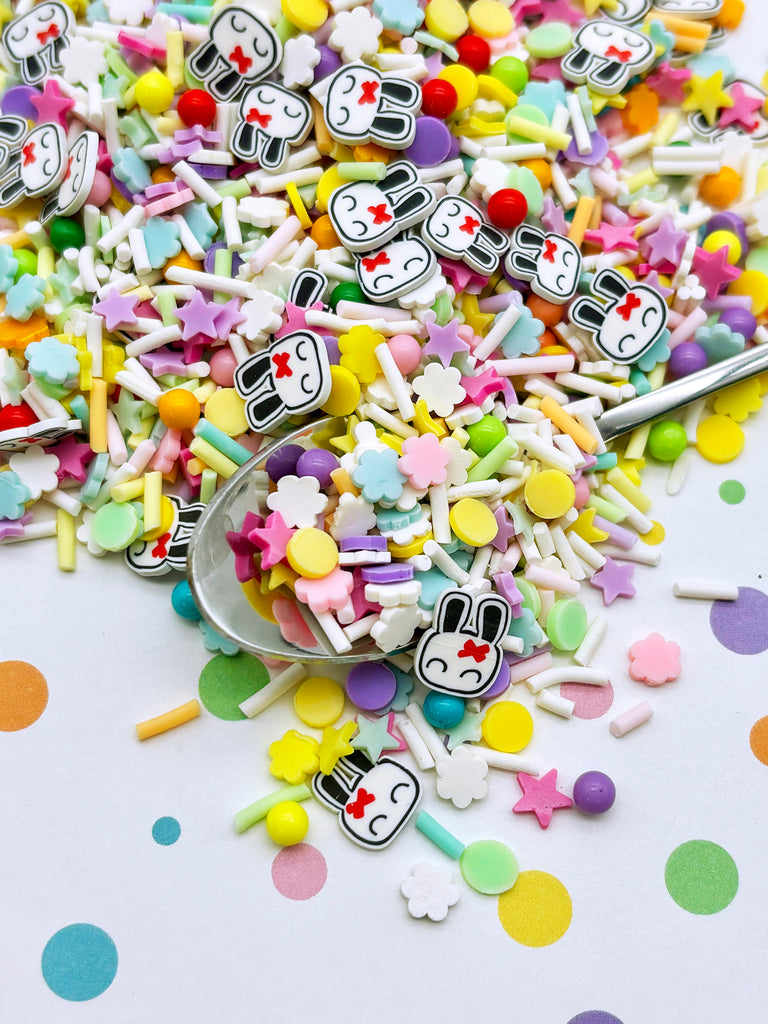 a spoon filled with lots of colorful candies