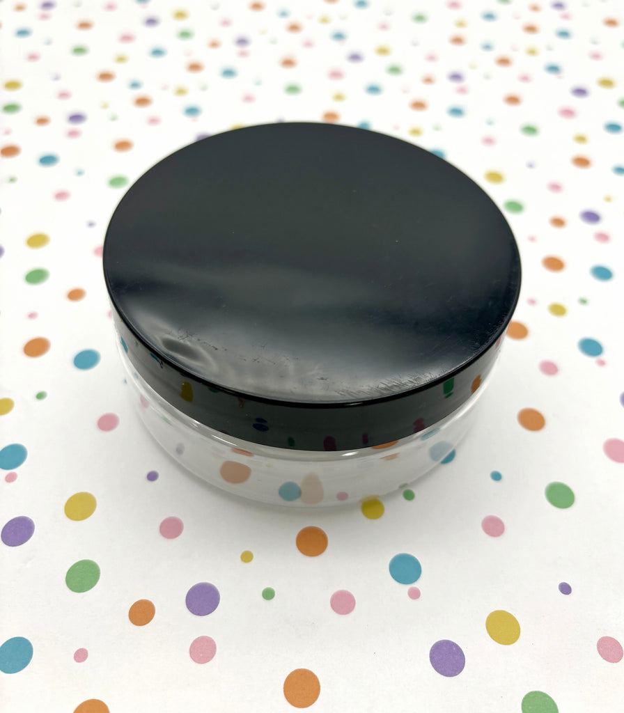 a black lid on a white container on a polka dot tablecloth