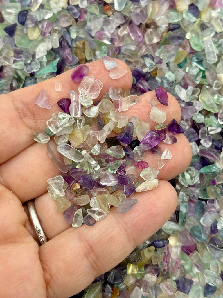 a person holding a handful of crystals in their hand