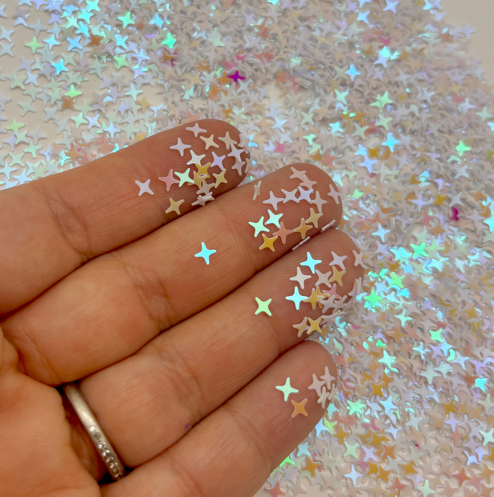a person's hand with gold stars on it