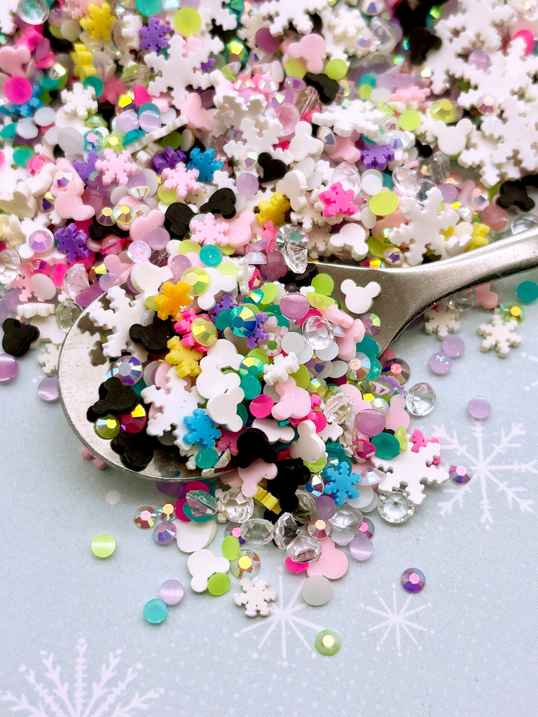 a spoon full of colorful sprinkles on a table