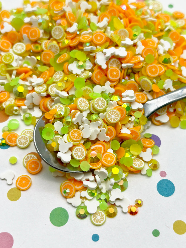 a spoon full of orange and white buttons