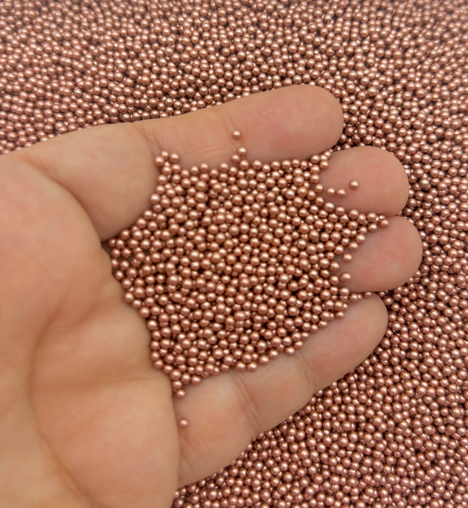 a hand is holding a small amount of beads