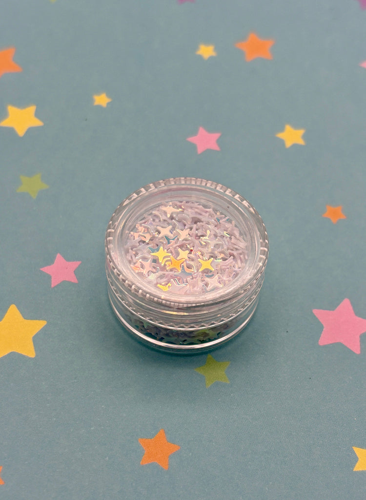 a small jar of glitter sitting on top of a table