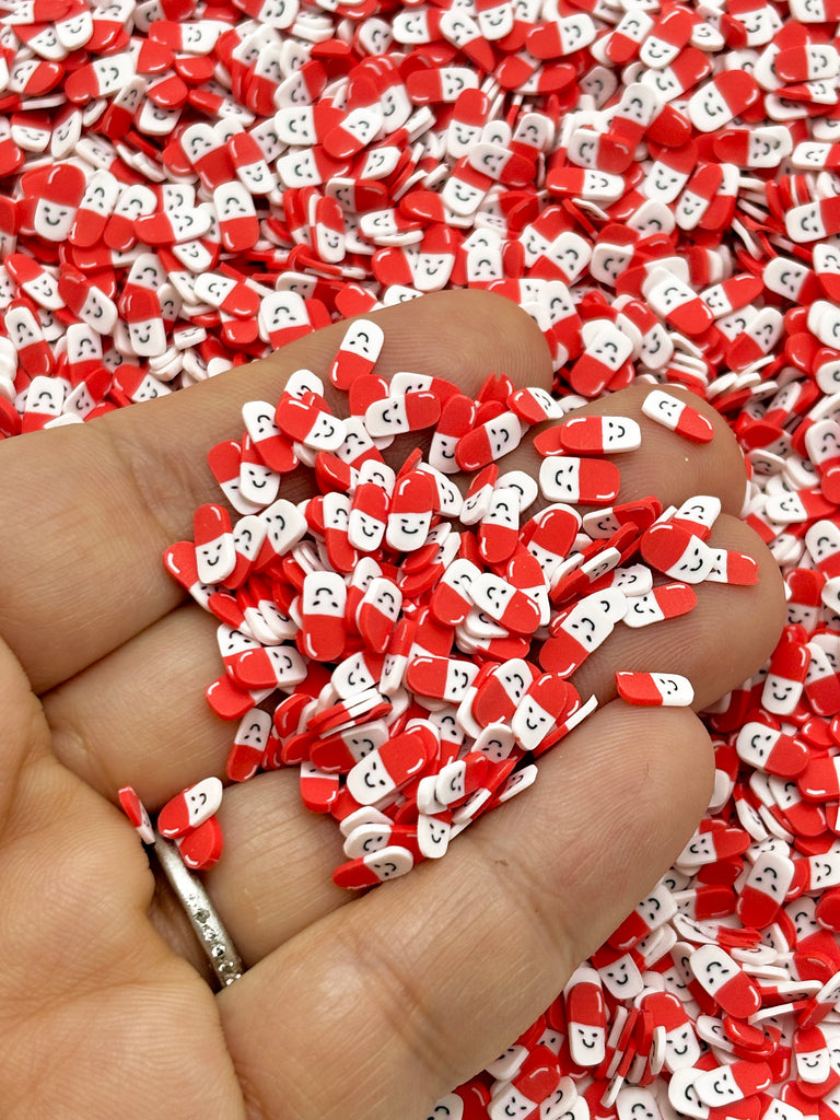 a hand holding a bunch of red and white hearts