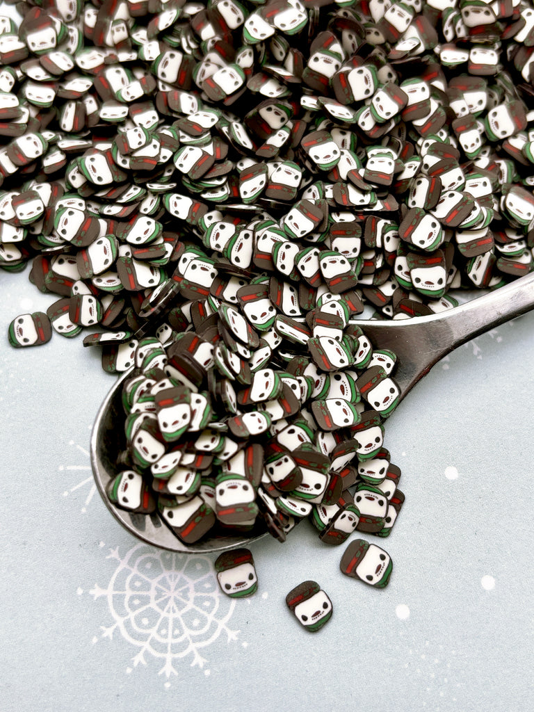 a spoon full of dices sitting on top of a table