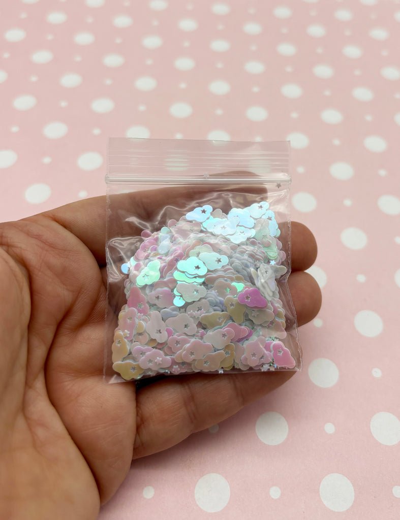a hand holding a small bag of confetti