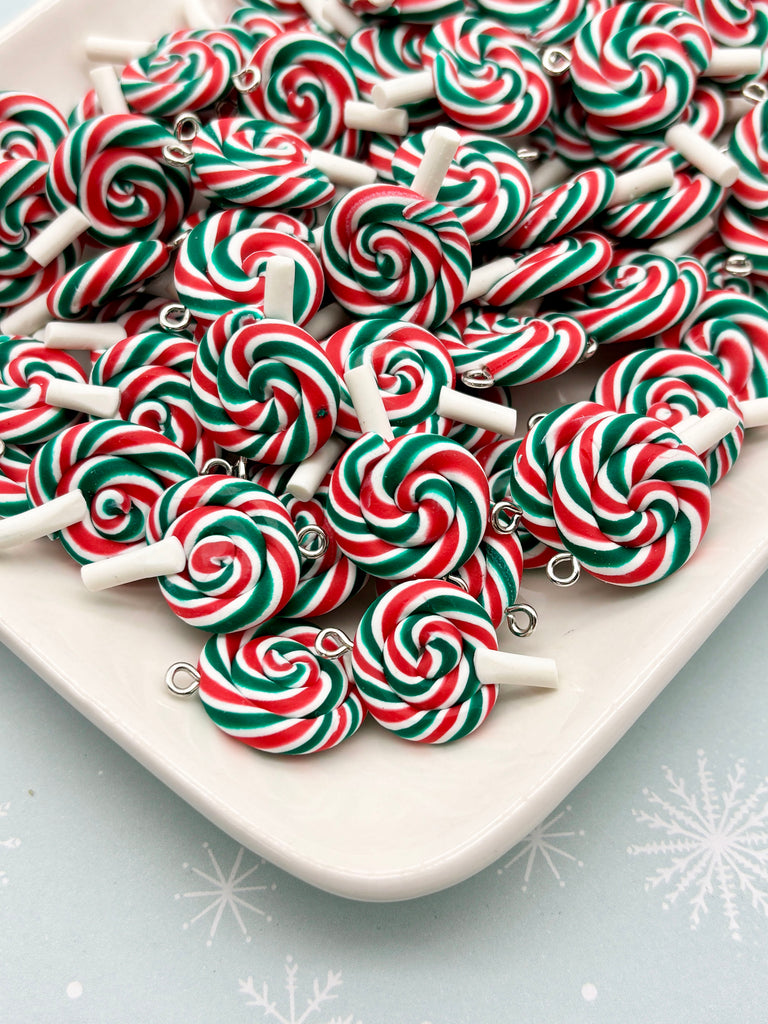 a white plate filled with colorful, spiral-shaped candies in red, green, and white colors, arranged in a visually appealing manner.