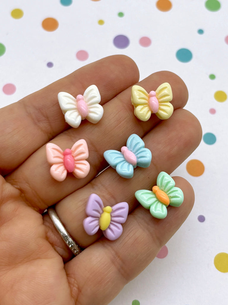 a person is holding five small bows in their hand