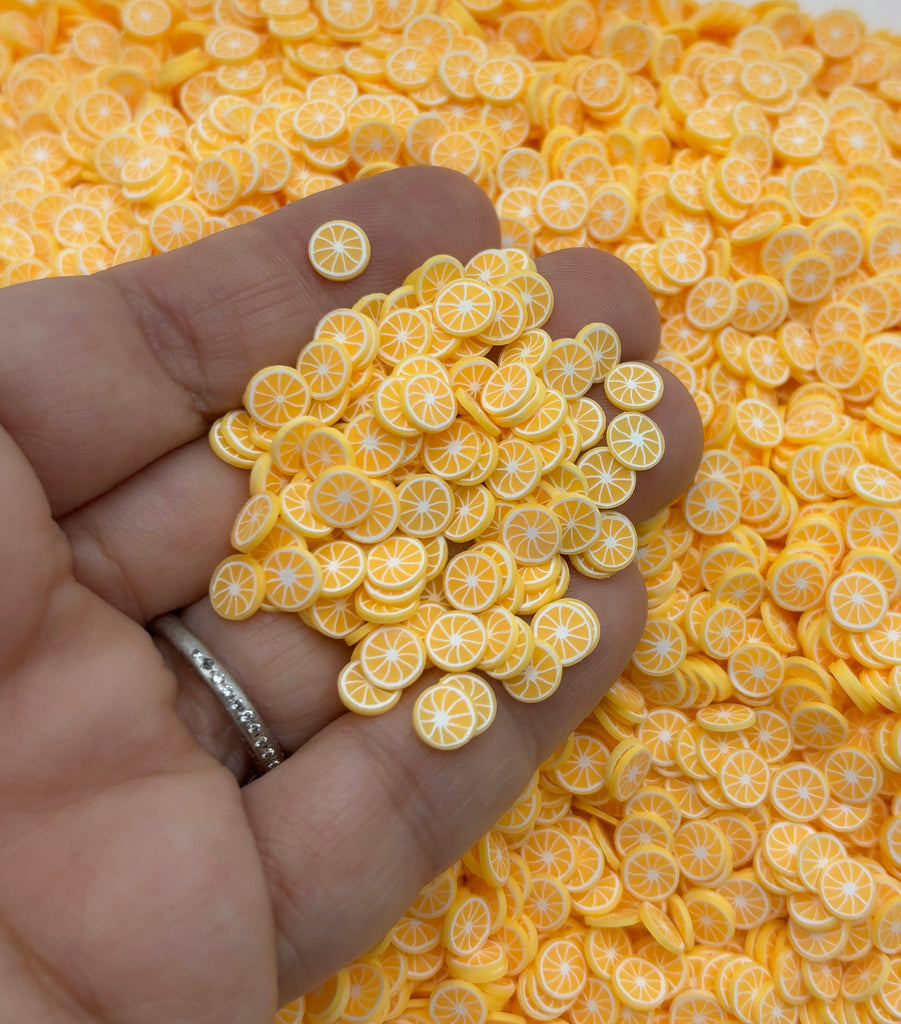 a person holding a handful of orange slices