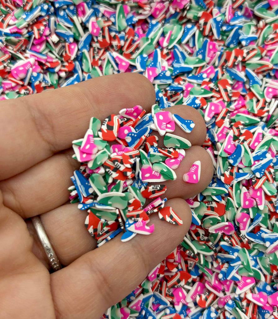 a hand holding a pile of colorful sprinkles