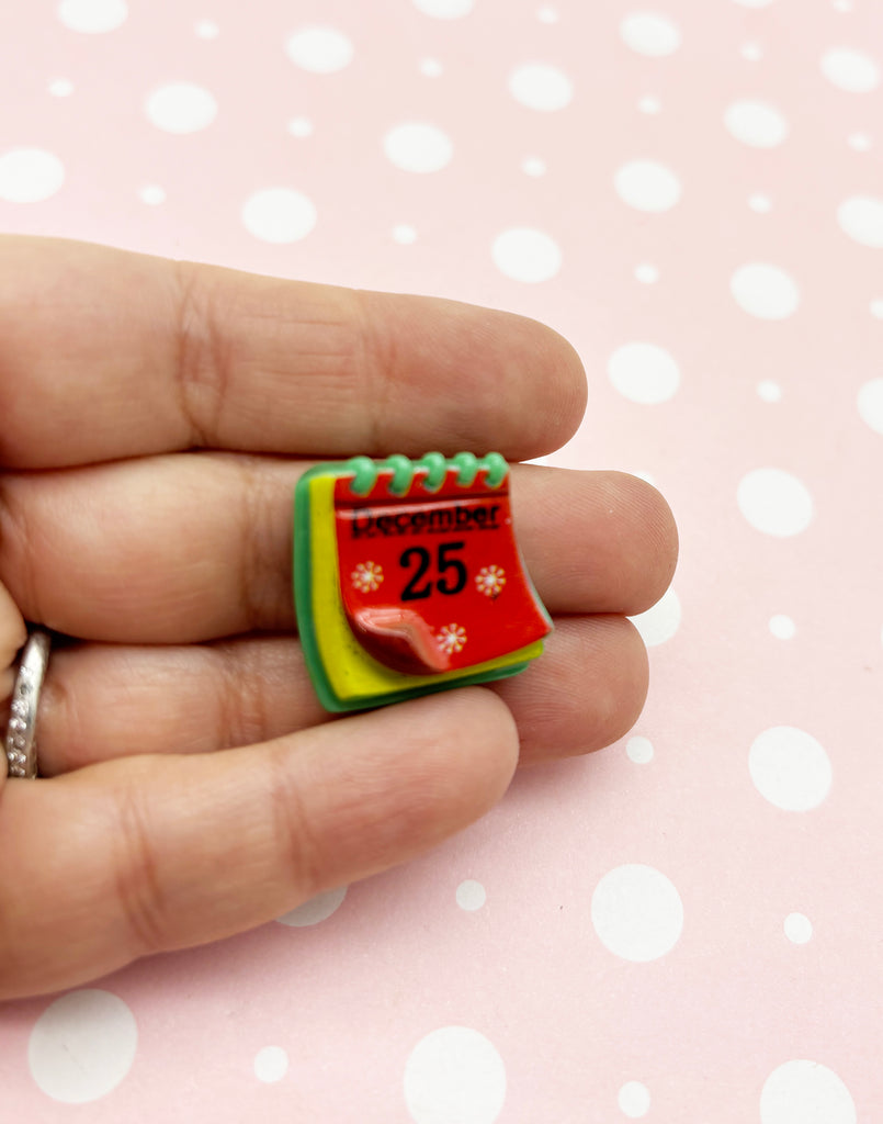 a person is holding a ring with a calendar on it