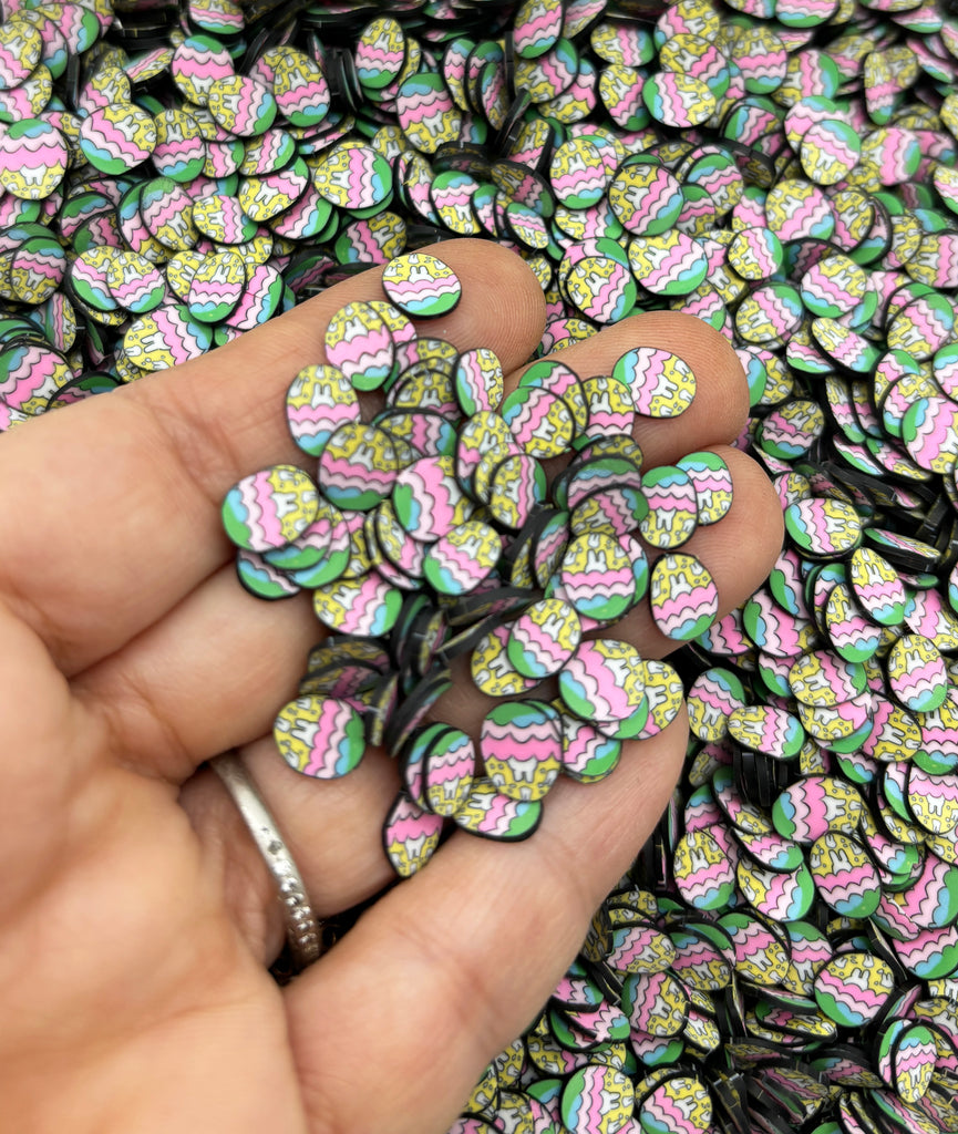 a person is holding a bunch of colorful buttons