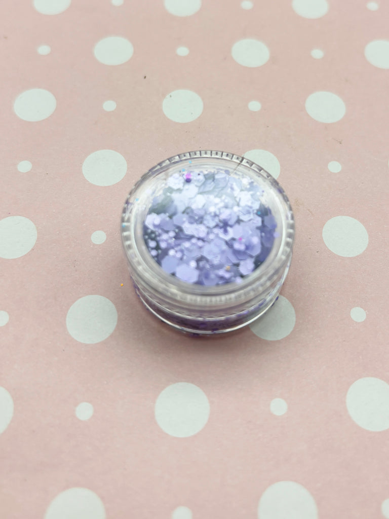 a jar of glitter sitting on top of a polka dot tablecloth