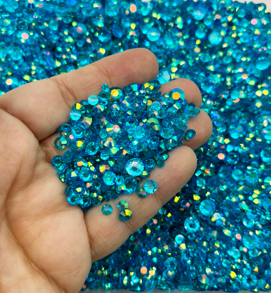 a hand holding a small amount of blue glitter
