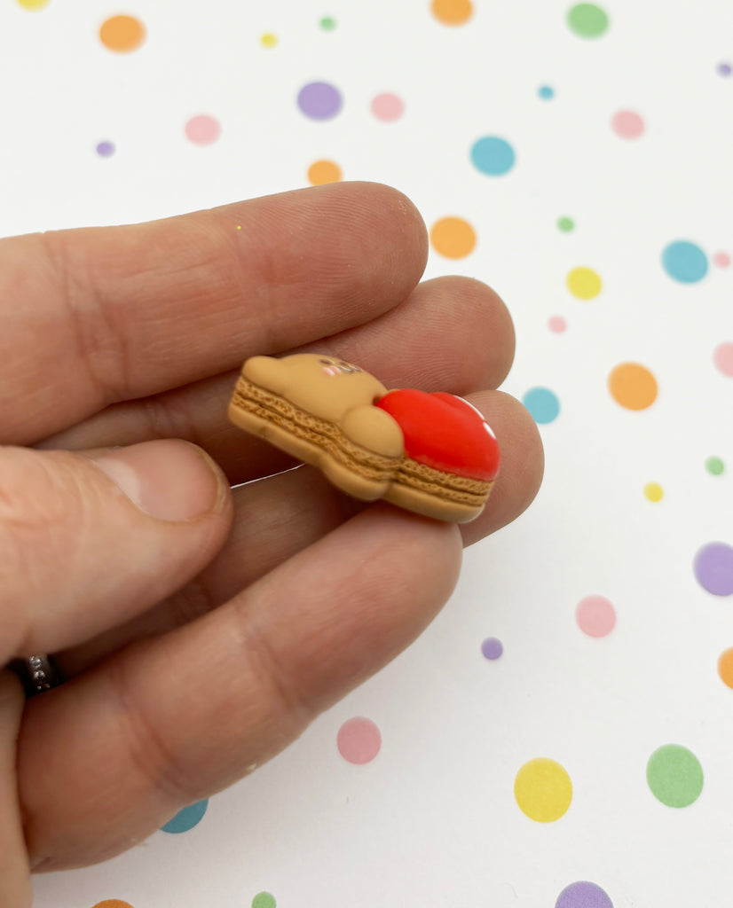 a person is holding a tiny cookie in their hand