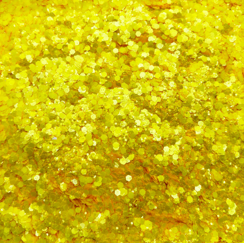 a close up of a yellow glitter background